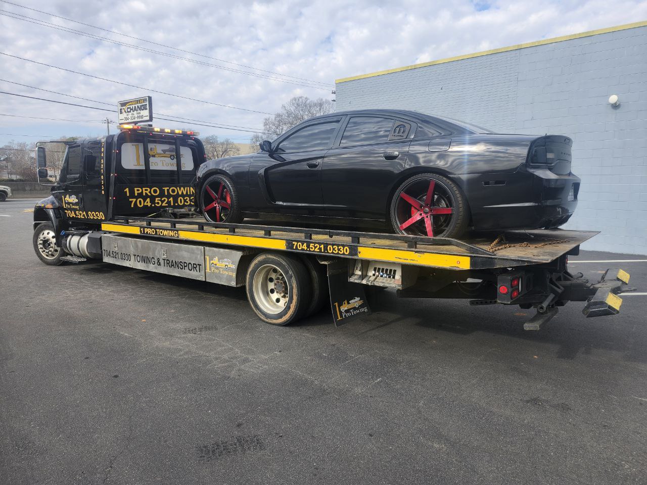 1 Pro Towing flatbed loaded with a Dodge Charger